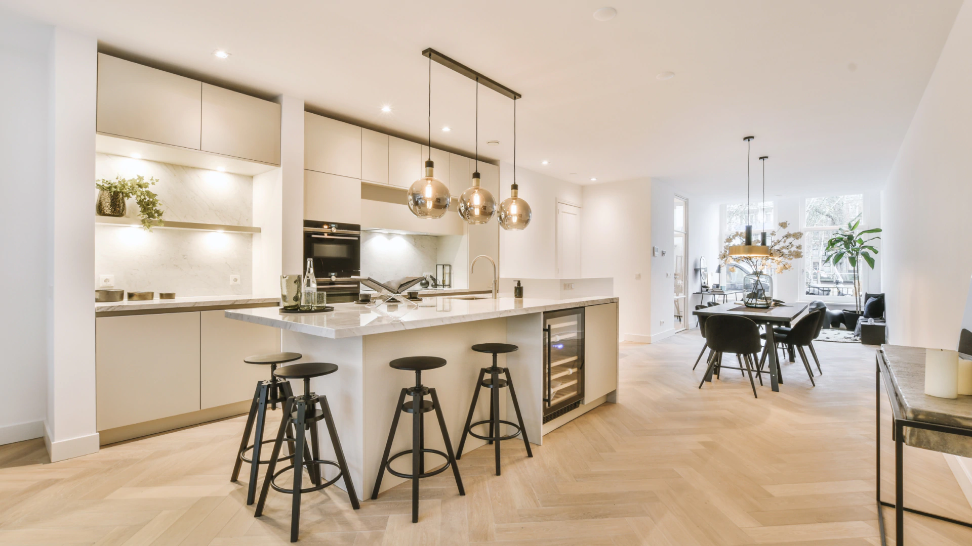 luxurious kitchen with hanging lights over island countertop